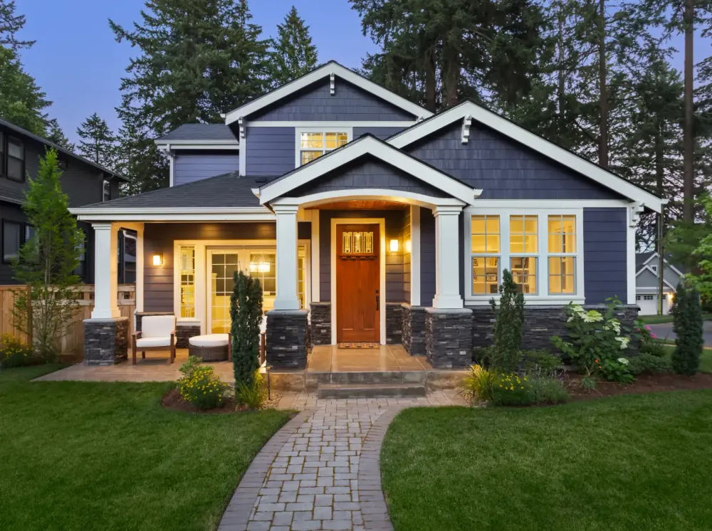 Blue single family home with many white pillars.
