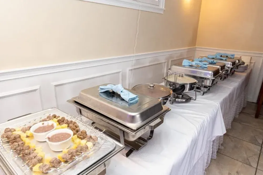 A buffet of delicious food from Sazon Cooperative in metal trays