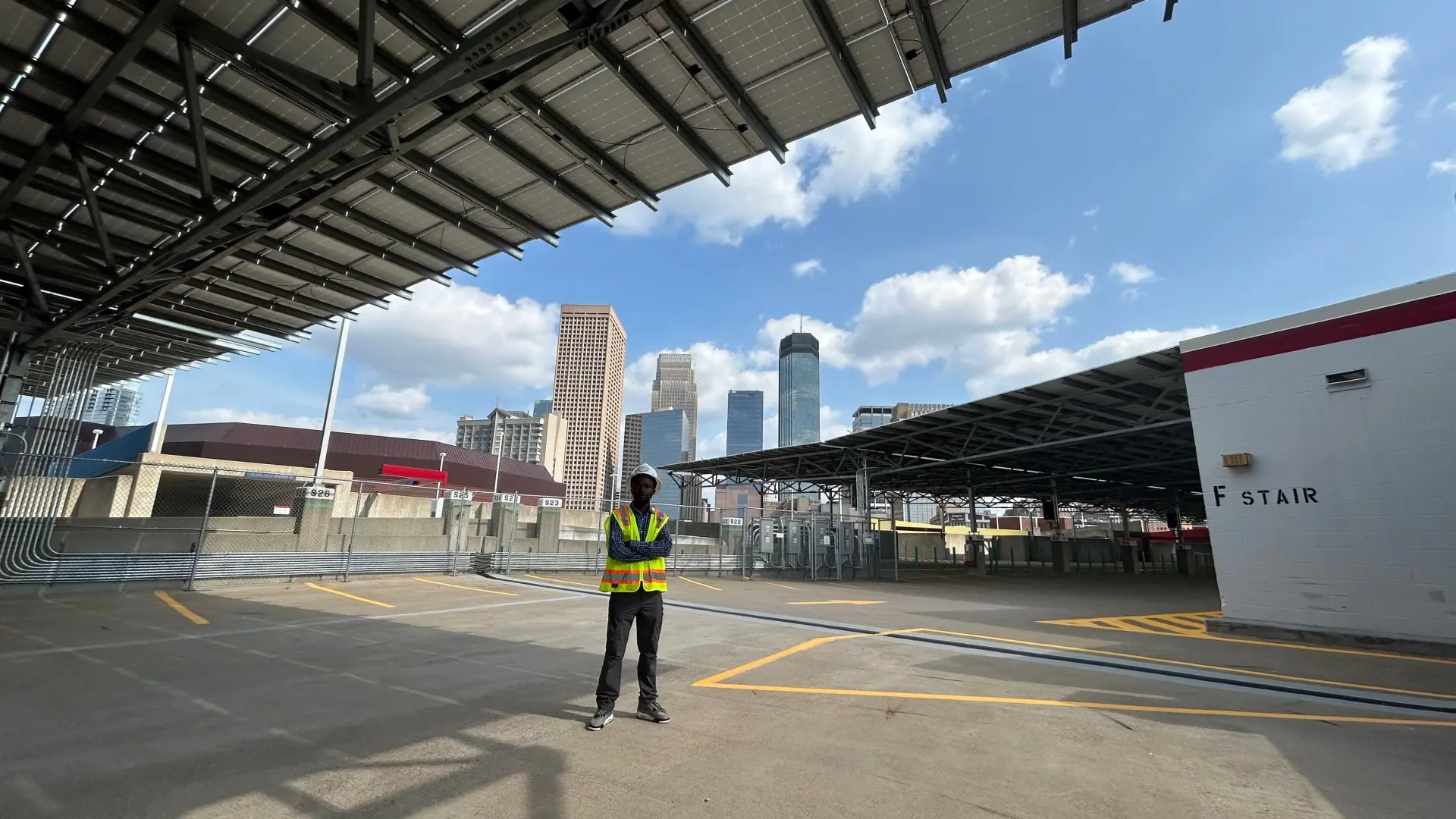 Person standing underneath a bridge at a construction site.