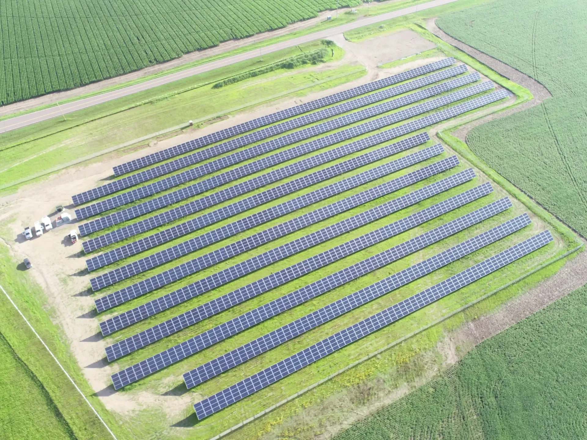 An aerial picture of a field of solar panels, approximately 10 rows deep